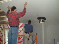 David and Jonathan dry walling the ceiling