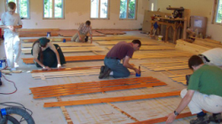 Teamwork staining wood