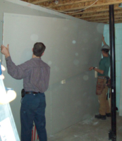 lifting drywalling into place